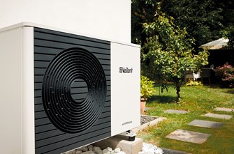 Vaillant aroTHERM plus air source heat pump installed in a lush green garden